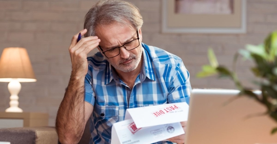 man looking at financial documents