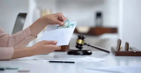 woman holding envelope with dollars