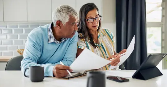Middle-aged ccouple reviewing finances